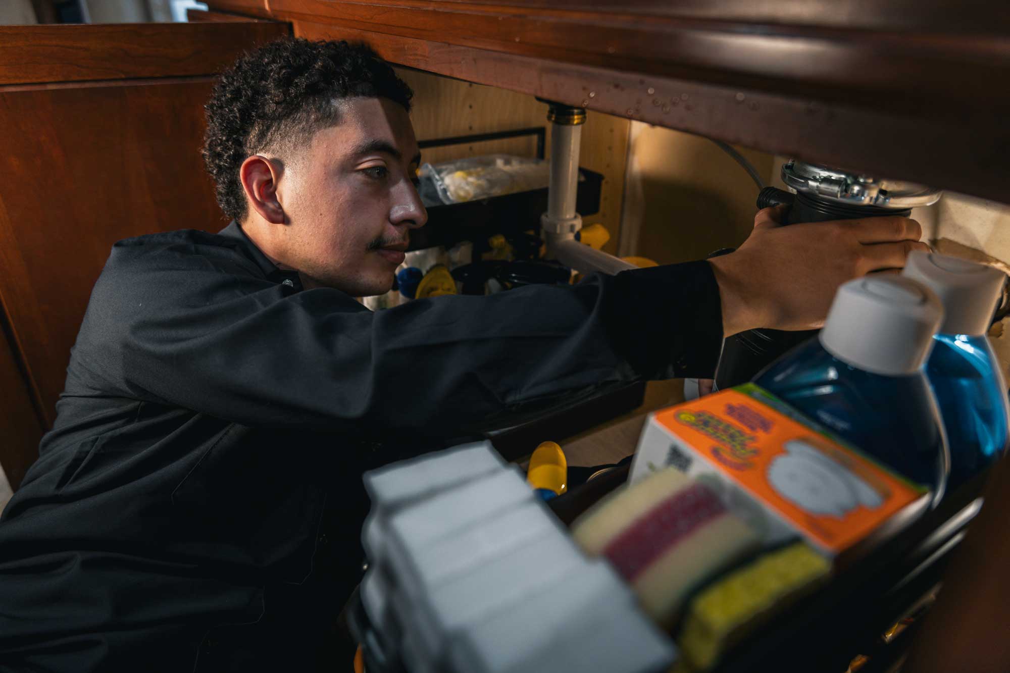 Maverick Plumbing technician working on a water heater at an Aptos, California home